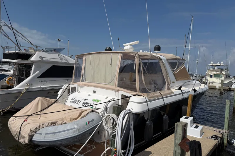 Slide: The Image of 2001 Tiara 35 Express yacht docked at marina with inflatable boat. - 24