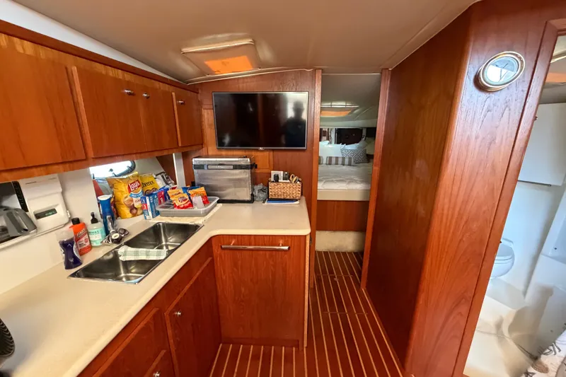 Slide: The Image of Interior of 2001 Tiara 35 Express yacht with kitchenette, TV, and cozy sleeping area. - 13