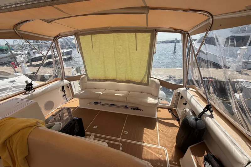 Slide: The Image of Interior view of 2001 Tiara 35 Express yacht with seating and marina backdrop. - 20