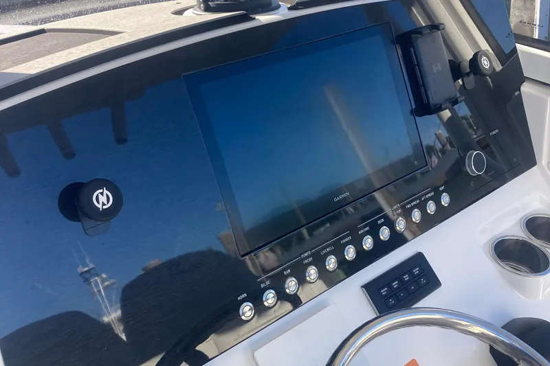 Slide: The Image of 2022 Regulator 26XO boat dashboard with Garmin display and control panel. - 19