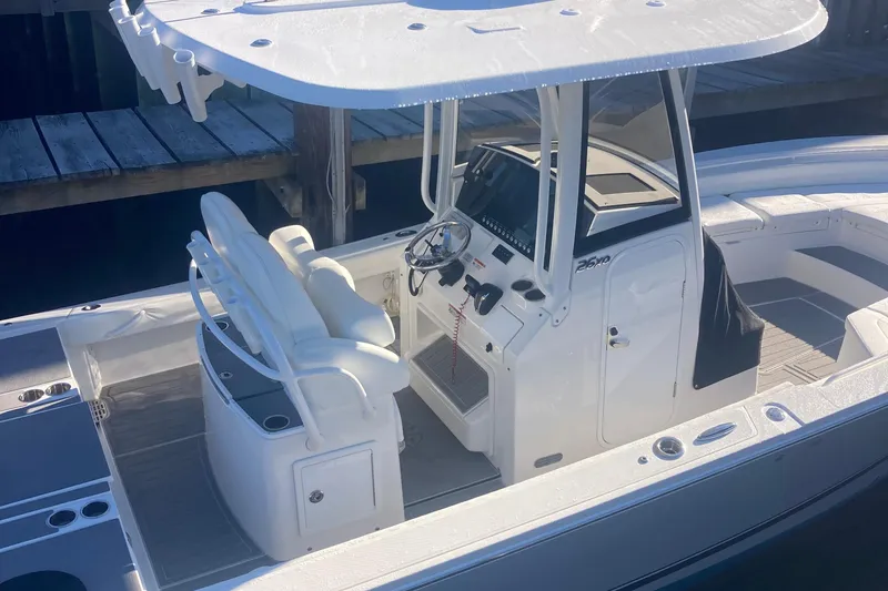 Slide: The Image of 2022 Regulator 26XO boat with center console and seating, docked in sunlight. - 5