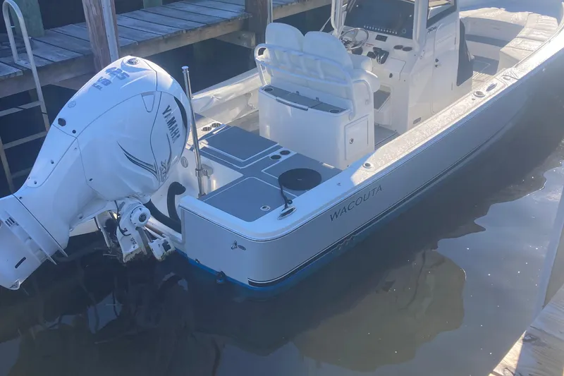 Slide: The Image of 2022 Regulator 26XO boat docked, featuring Yamaha outboard engine and sleek design. - 22
