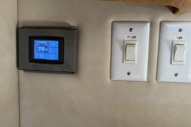 Slide: The Image of Thermostat and light switches on 1996 Sea Ray 450 Sundancer yacht interior wall. - 40