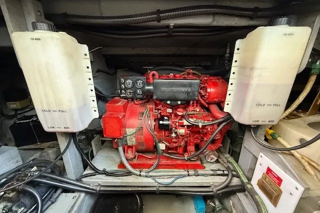 Slide: The Image of Engine compartment of a 1996 Sea Ray 450 Sundancer, featuring a red marine engine. - 52