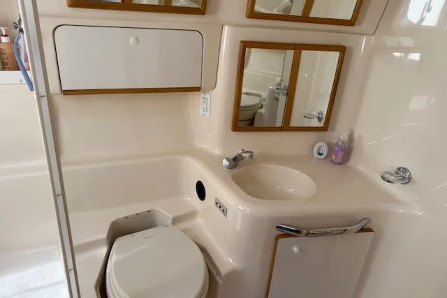 Slide: The Image of Bathroom interior of 1996 Sea Ray 450 Sundancer yacht, featuring sink and toilet. - 38