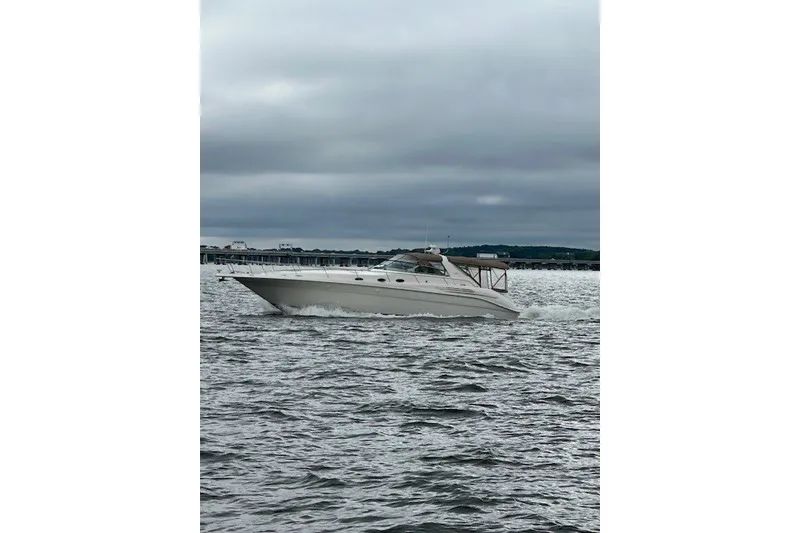 Slide: The Image of 1996 Sea Ray 450 Sundancer cruising on a cloudy day. - 2
