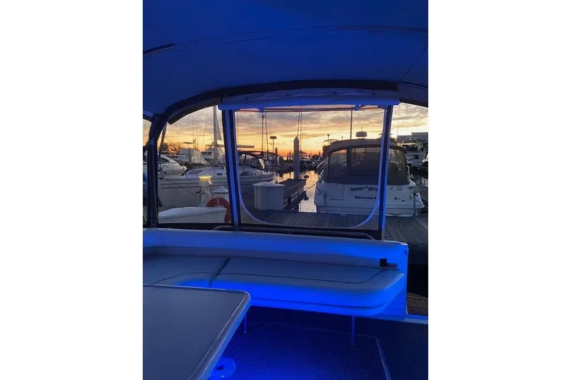 Slide: The Image of Interior view of a 1996 Sea Ray 450 Sundancer yacht at sunset in a marina. - 13