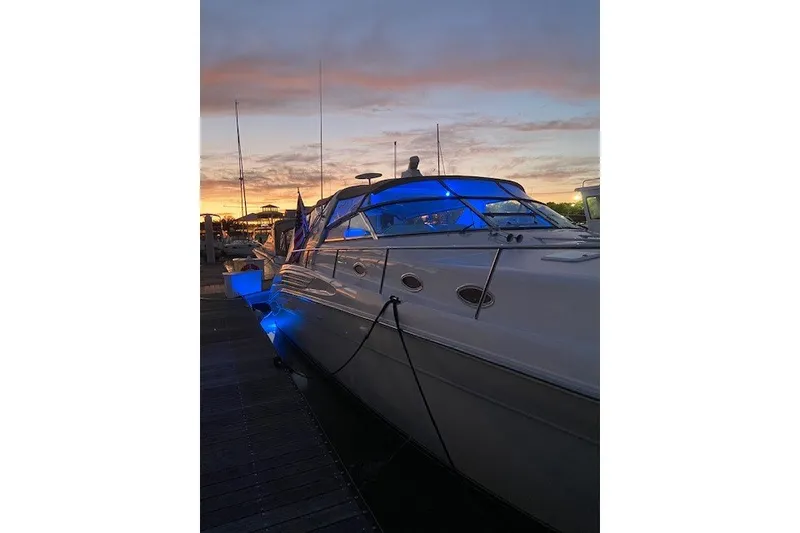 Slide: The Image of 1996 Sea Ray 450 Sundancer yacht docked at sunset with blue lights. - 4