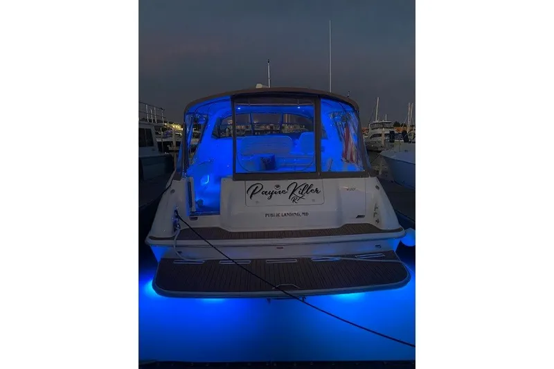 Slide: The Image of 1996 Sea Ray 450 Sundancer yacht with blue LED lights at night. - 8