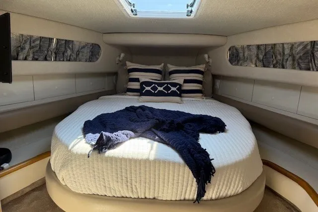 Slide: The Image of Luxurious 1996 Sea Ray 450 Sundancer cabin with cozy bed and nautical decor. - 33