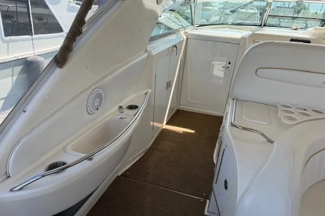 Slide: The Image of 1996 Sea Ray 450 Sundancer interior with white seating and sleek design. - 17