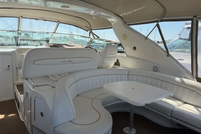 Slide: The Image of 1996 Sea Ray 450 Sundancer yacht interior with white seating and table. - 16