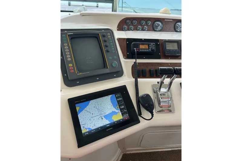 Slide: The Image of Cockpit of 1996 Sea Ray 450 Sundancer with navigation and communication equipment. - 12