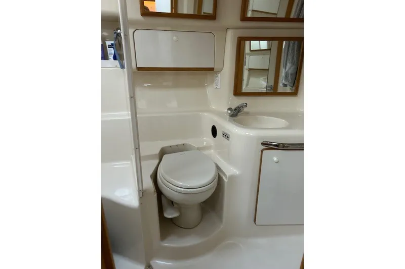 Slide: The Image of Bathroom interior of 1996 Sea Ray 450 Sundancer yacht, featuring toilet and sink. - 20