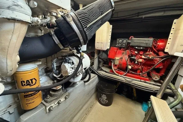 Slide: The Image of Engine room of a 1996 Sea Ray 450 Sundancer, featuring CAT and red machinery. - 51