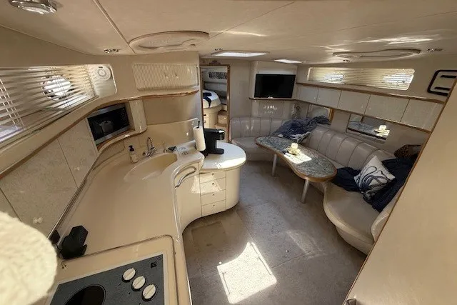 Slide: The Image of Luxurious interior of a 1996 Sea Ray 450 Sundancer yacht, featuring a cozy seating area and modern amenities. - 23