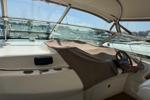 Slide: The Image of 1996 Sea Ray 450 Sundancer yacht interior with covered dashboard and steering wheel. - 18