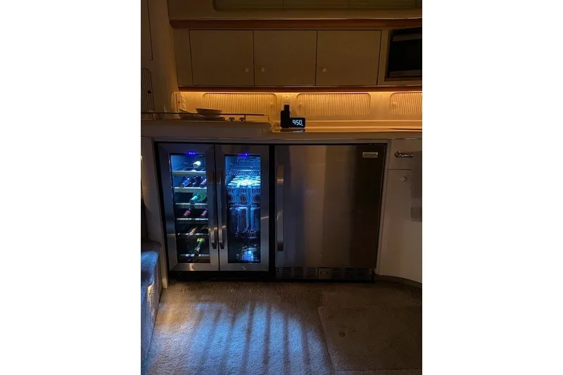 Slide: The Image of Interior of a 1996 Sea Ray 450 Sundancer with illuminated wine cooler and fridge. - 17