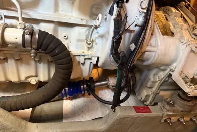 Slide: The Image of Engine compartment of a 1996 Sea Ray 450 Sundancer boat, showcasing mechanical components. - 49