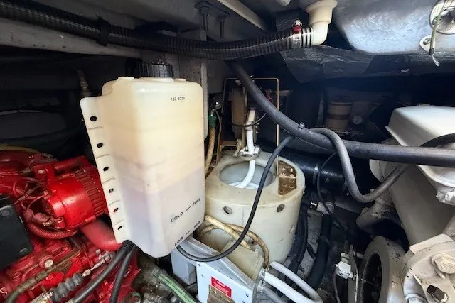 Slide: The Image of Engine compartment of a 1996 Sea Ray 450 Sundancer boat, showcasing mechanical components. - 53