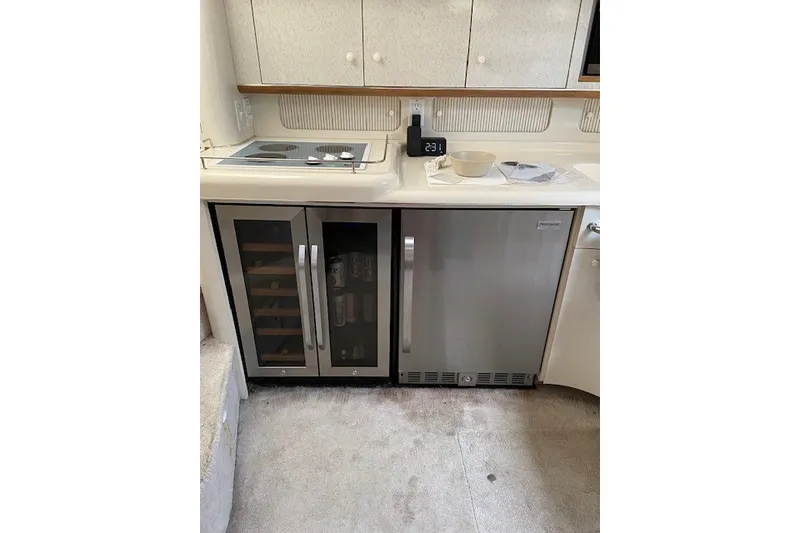 Slide: The Image of Kitchen area of a 1996 Sea Ray 450 Sundancer yacht with modern appliances. - 18