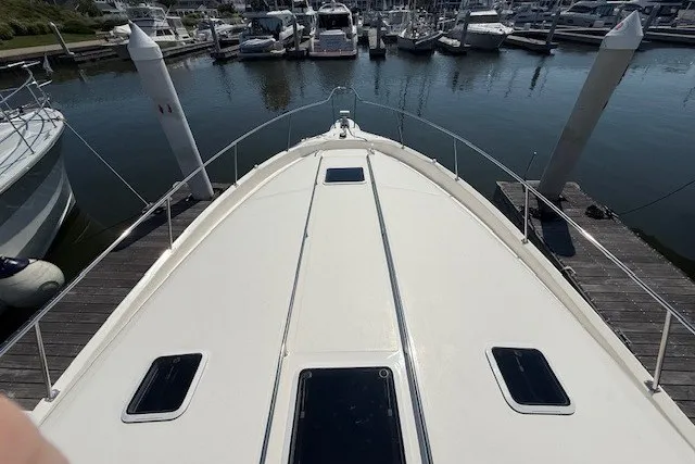 Slide: The Image of 1996 Sea Ray 450 Sundancer yacht docked at marina, view from bow. - 5