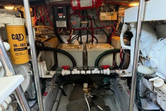 Slide: The Image of Engine room of a 1996 Sea Ray 450 Sundancer with CAT filters and battery setup. - 43