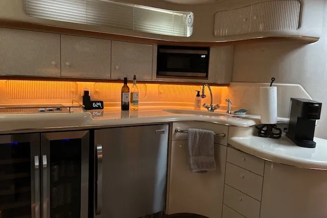 Slide: The Image of Luxurious kitchen interior of 1996 Sea Ray 450 Sundancer yacht with modern appliances. - 16