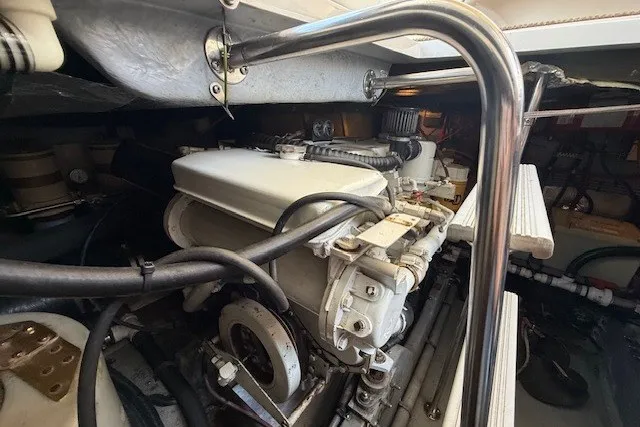 Slide: The Image of Engine compartment of a 1996 Sea Ray 450 Sundancer, showcasing mechanical components and piping. - 45