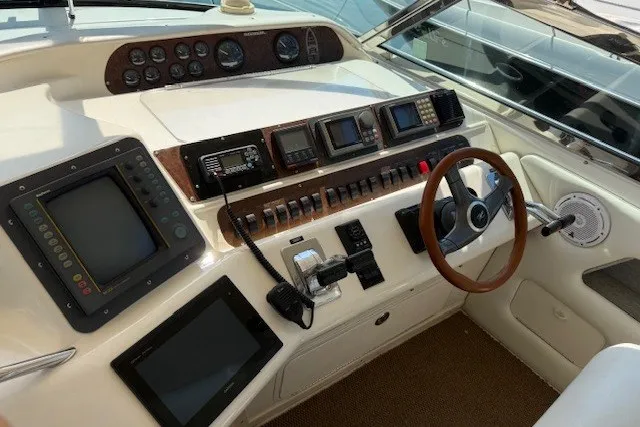 Slide: The Image of Control panel of a 1996 Sea Ray 450 Sundancer yacht with navigation instruments. - 19