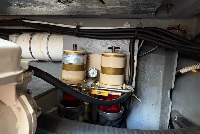 Slide: The Image of Engine compartment of a 1996 Sea Ray 450 Sundancer with fuel filters and hoses. - 48