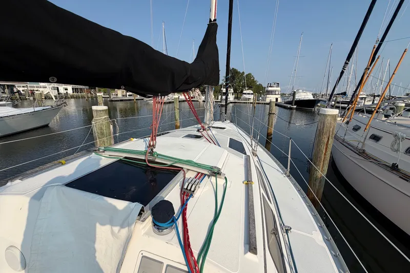 Slide: The Image of 1989 Hunter 30 sailboat docked at marina, featuring deck and rigging details. - 9