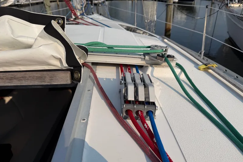 Slide: The Image of Deck of 1989 Hunter 30 sailboat with colorful ropes and cleats in marina. - 15