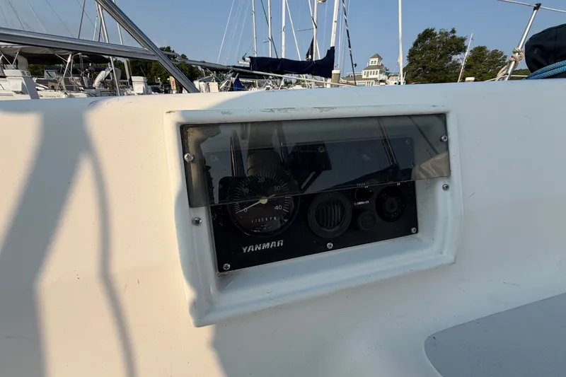 Slide: The Image of Control panel on a 1989 Hunter 30 sailboat, featuring Yanmar engine gauges. - 8