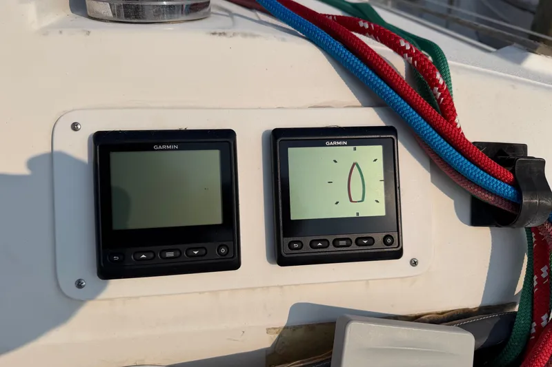 Slide: The Image of Garmin navigation displays on 1989 Hunter 30 sailboat, with colorful ropes nearby. - 14