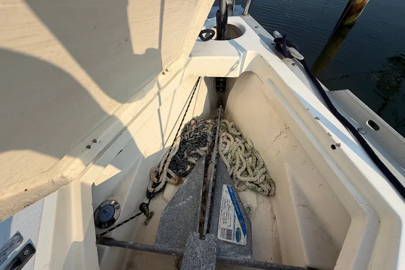 Slide: The Image of Anchor locker of a 1989 Hunter 30 sailboat with ropes and anchor. - 12