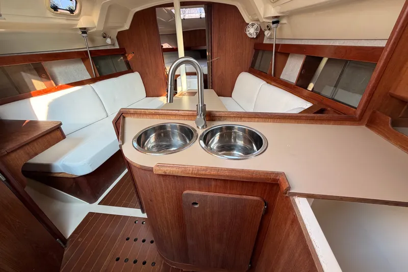 Slide: The Image of Interior of a 1989 Hunter 30 sailboat with wood finish and dual sinks. - 22