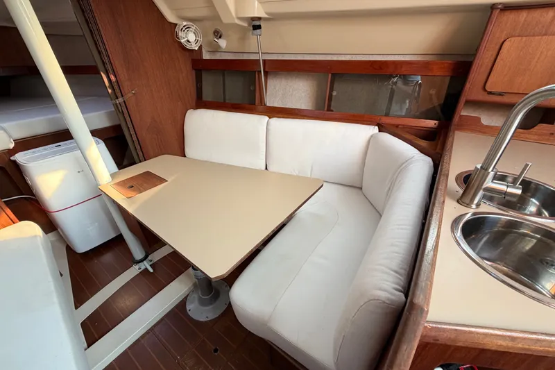 Slide: The Image of Interior of 1989 Hunter 30 sailboat with cozy dining area and compact kitchen. - 27