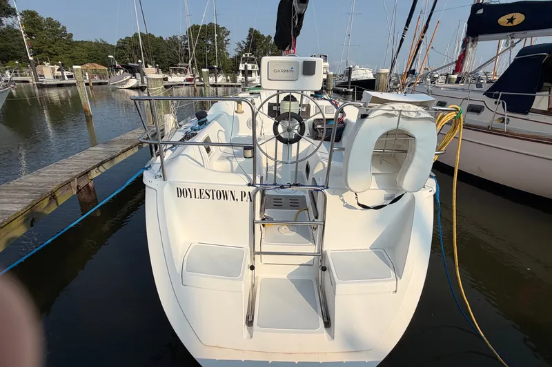 Slide: The Image of 1989 Hunter 30 sailboat docked at marina, featuring a Garmin navigation system. - 3
