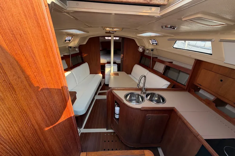 Slide: The Image of Interior of a 1989 Hunter 30 sailboat with wood finish and compact kitchen area. - 16