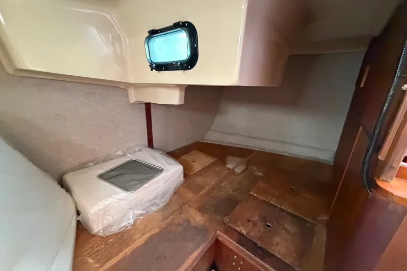 Slide: The Image of Interior cabin of a 1989 Hunter 30 sailboat, featuring a compact storage area. - 18