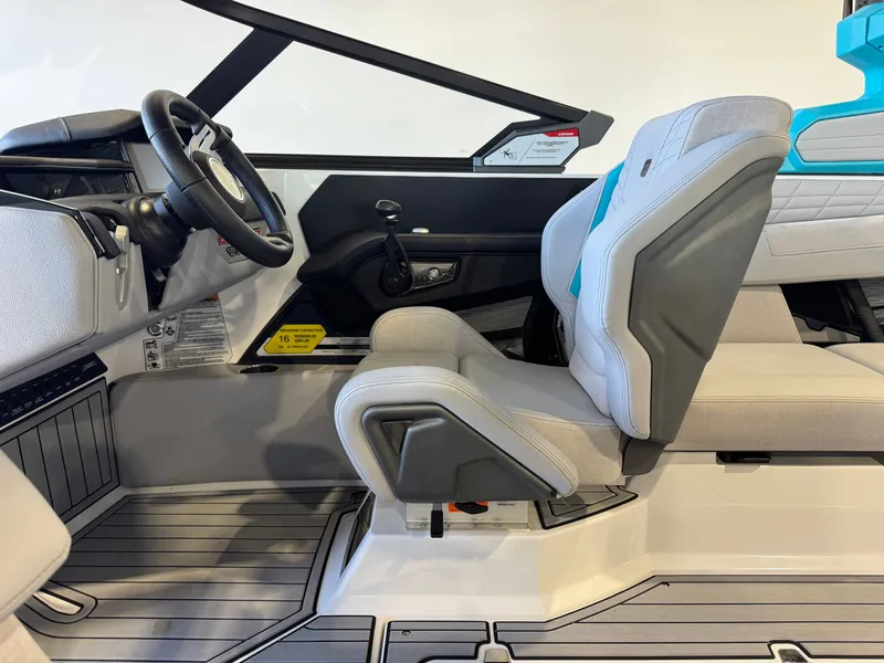 Slide: The Image of The image shows the interior of a 2024 Nautique Super Air Nautique G23 with modern seating and steering wheel. - 24