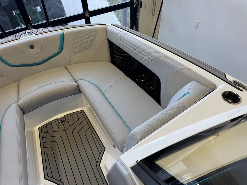 Slide: The Image of The image shows the interior of a 2024 Super Air Nautique G23 with sleek, upholstered seating. - 19