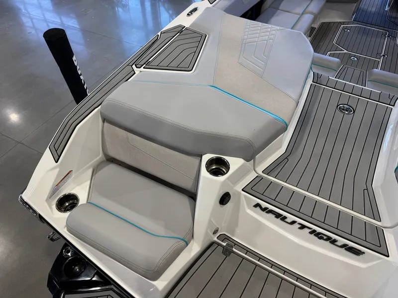 Slide: The Image of The image shows the stern of a 2024 Super Air Nautique G23 with gray upholstery and cup holders. - 13