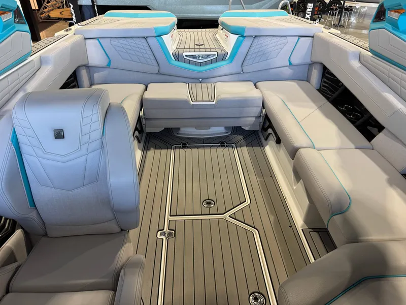 Slide: The Image of The image shows the interior of a 2024 Nautique Super Air Nautique G23 with gray and blue upholstery. - 23