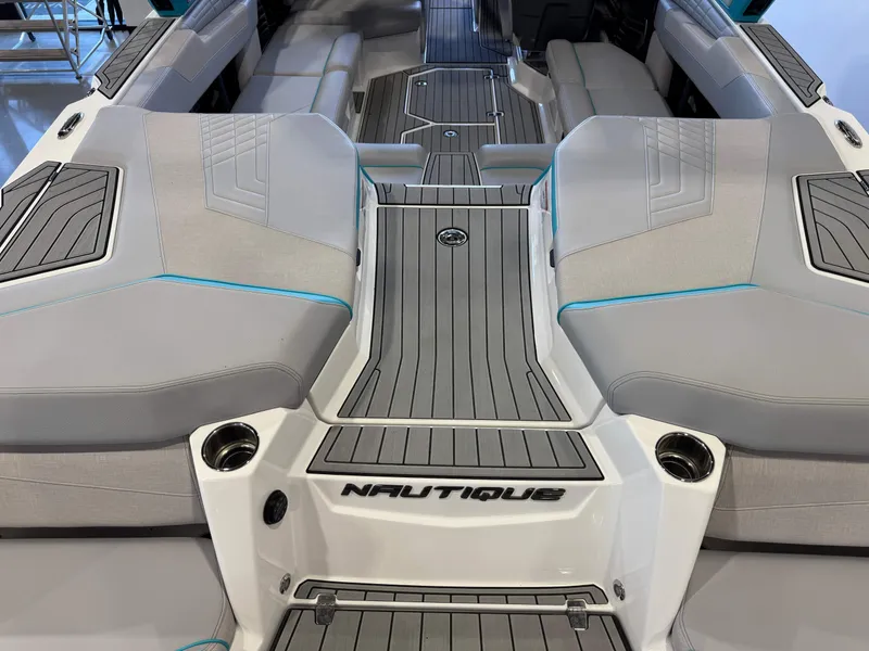 Slide: The Image of The image shows the stern of a 2024 Super Air Nautique G23 with gray upholstery and teak-style decking. - 11