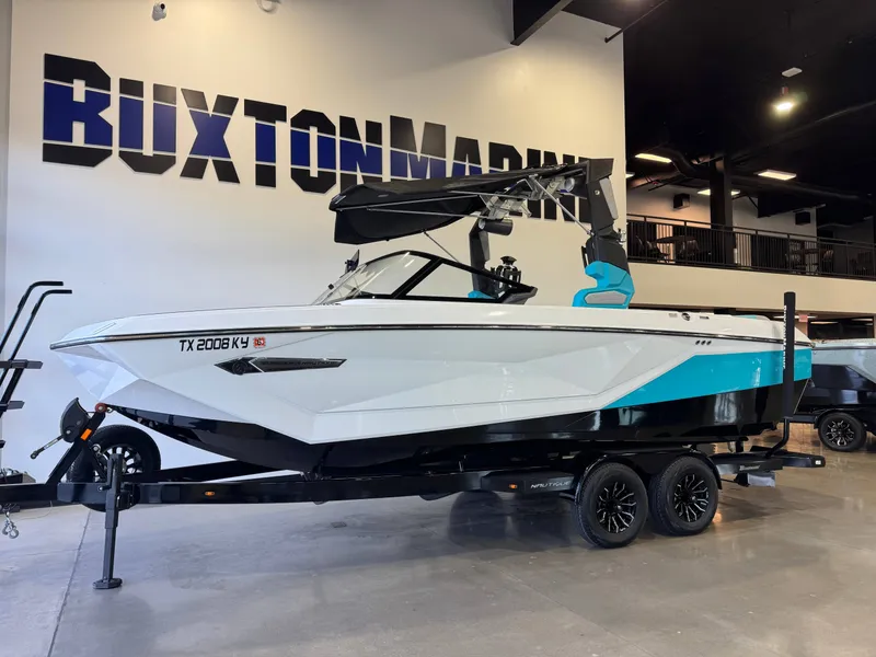 Slide: The Image of A 2024 Super Air Nautique G23 on a trailer in a showroom. - 3