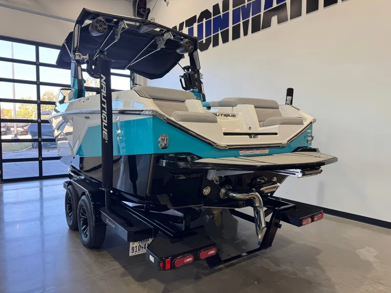 Slide: The Image of The image shows a 2024 Nautique Super Air Nautique G23 in a showroom setting. - 5