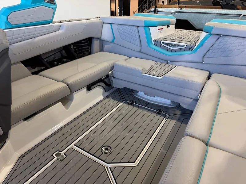 Slide: The Image of The image shows the interior of a 2024 Super Air Nautique G23 with gray and blue upholstery. - 16