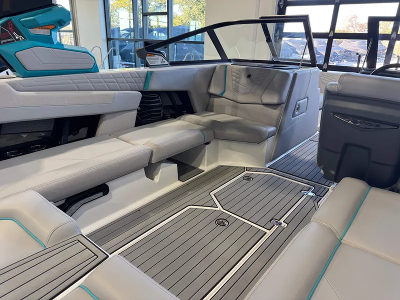 Slide: The Image of The image shows the interior of a 2024 Super Air Nautique G23 with sleek gray upholstery and modern details. - 15